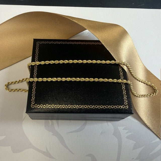 Black box with gold chain on a decorative background