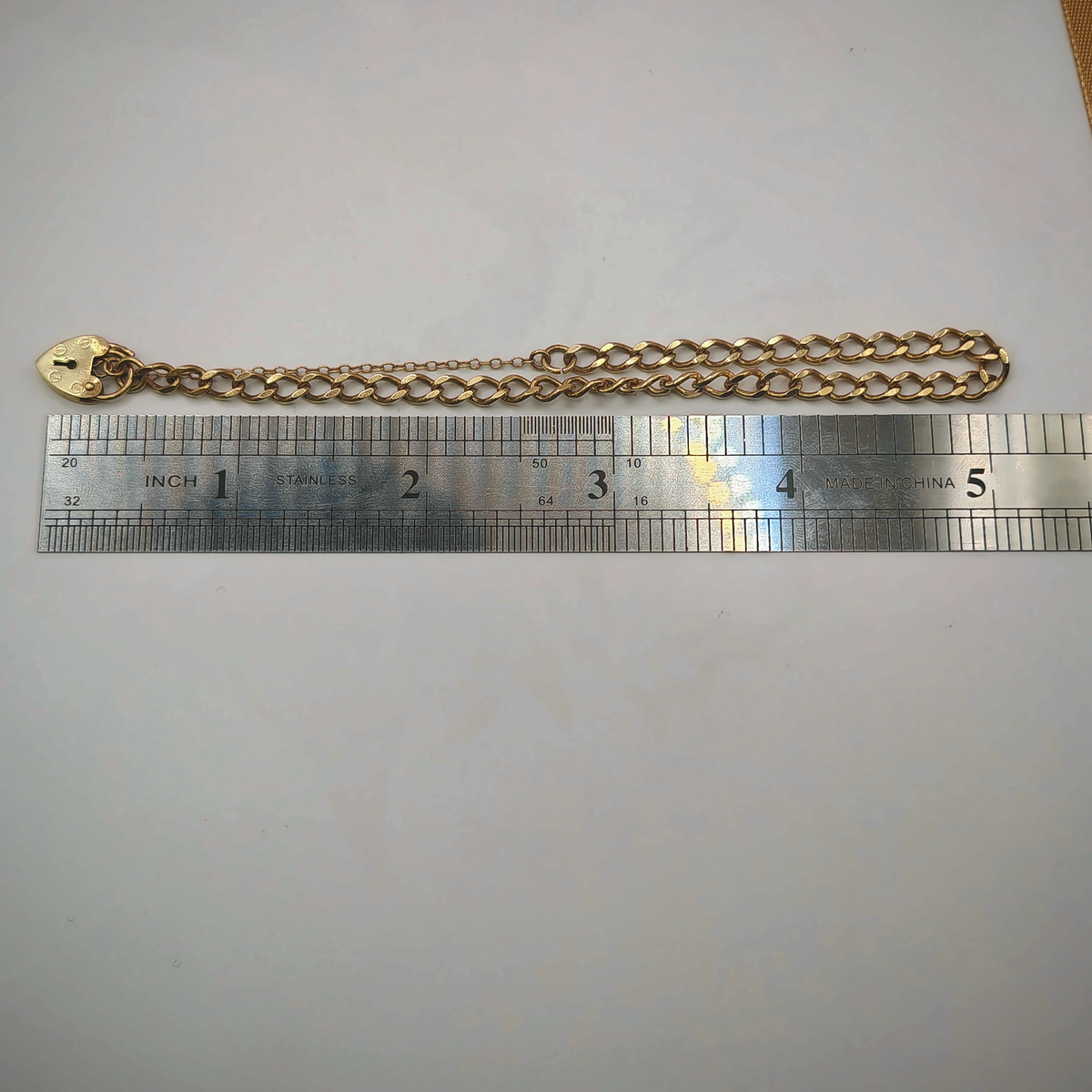 9ct Yellow Gold Curb Link Bracelet with Heart Padlock Clasp, photograph 8 of 8. SKU JB3627.